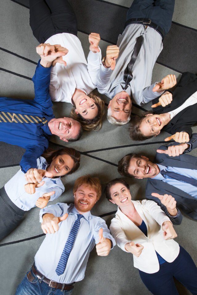 Cheerful Successful Business Team with Thumbs Up Team Building