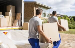 Reliable & Eco-Friendly Furniture Removal Services in Kent WA Professional movers carrying boxes from a truck during a furniture removal service in Kent, WA.