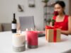 How to Store Soy Candles to Preserve Fragrance and Appearance Lit soy candles with gift box and woman holding rose in background